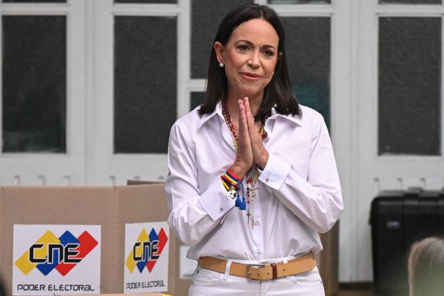 (FILES) Venezuelan opposition leader Maria Corina Machado gestures as she votes during the presidential election, in Caracas on July 28, 2024. On January 5, 2026, Venezuelan opposition leader Maria Corina Machado said she plans to return home "as soon as possible," and slammed the interim leader in Caracas. (Photo by Federico PARRA / AFP)