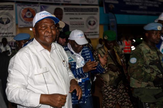 (FILES) Central African Republic President Faustin Archange Touadéra (L) attends The United Hearts Movement (MCU) conference in Bangui on July 26, 2025 where he announced his candidacy for the presidential election scheduled for December 2025, seeking a third consecutive term. The Central African Republic has re-elected President Faustin Archange Touadera, according to provisional results released by the electoral authority on January 6, 2026. (Photo by Annela NIAMOLO / AFP)