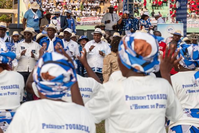 (FILES) Central African Republic's President and presidential candidate for the United Hearts Movement (MCU) Faustin Archange Touadera (C) dances during his final rally in Bangui on December 26, 2025 ahead of CAR's presidential election on December 28, 2025. The Central African Republic has re-elected President Faustin Archange Touadera, according to provisional results released by the electoral authority on January 6, 2026. (Photo by Annela NIAMOLO / AFP)