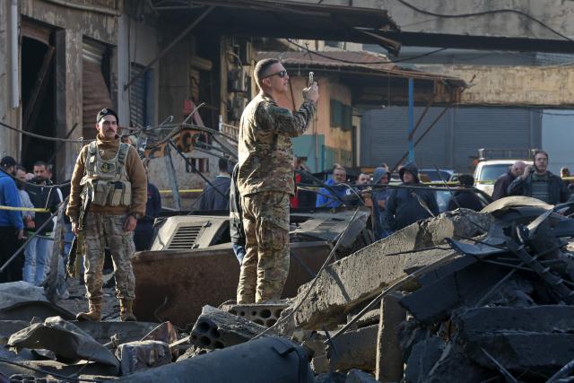 Security personnel inspect the site of a building that was destroyed by the Israeli strike in the industrial area of Ghazieh town, near the coastal city of Sidon, in southern Lebanon on January 6, 2026. The Israeli military launched strikes on southern and eastern Lebanon on January 5, 2026, Lebanese state media reported, after warning it would hit what it called Hezbollah and Hamas targets in four villages. It was the first such warning issued by the Israeli military this year, as Israel continues to strike targets in Lebanon despite a ceasefire with Hezbollah. (Photo by MAHMOUD ZAYYAT / AFP)