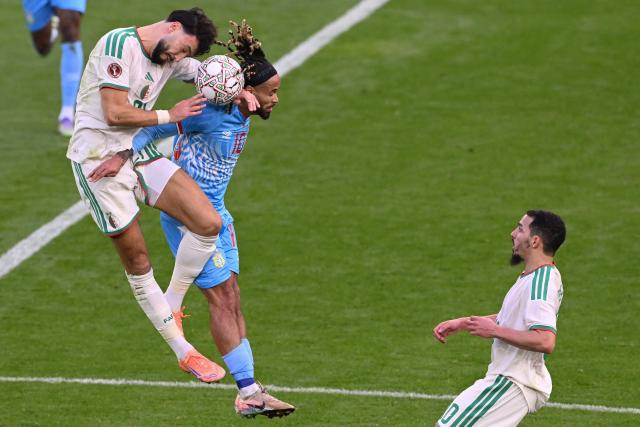 Algeria's midfielder #22 Ibrahim Maza (L) and Democratic Republic Of Congo's forward #10 Theo Bongonda jump for the ball during the Africa Cup of Nations (CAN) round of 16 football match between Algeria and Democratic Republic of Congo at the Prince Moulay El Hassan
Stadium in Rabat on January 6, 2026. (Photo by SEBASTIEN BOZON / AFP)