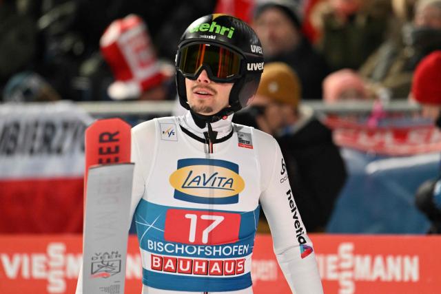 Switzerland's Sandro Hauswirth reacts after competing in the Men's Individual Large Hill HS142 event of the FIS Ski Jumping World Cup, the fourth and last leg of the Four Hills Tournament, in Bischofshofen, Austria on January 6, 2026. (Photo by KERSTIN JOENSSON / AFP)