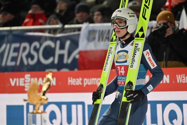 Poland's Kacper Tomasiak reacts after competing in the Men's Individual Large Hill HS142 event of the FIS Ski Jumping World Cup, the fourth and last leg of the Four Hills Tournament, in Bischofshofen, Austria on January 6, 2026. (Photo by KERSTIN JOENSSON / AFP)