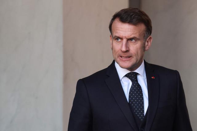 France's President Emmanuel Macron reacts as he waits for the arrival of Chiefs of State at the Elysee Palace in Paris, on January 6, 2026, prior to the Coalition of the Willing summit on security guarantees for Ukraine. The summit of the group of Ukraine supporters dubbed the "Coalition of the Willing" is the latest of several meetings planned for the new year as diplomatic efforts to end Europe's deadliest conflict since World War II have gained pace in recent weeks. (Photo by Ludovic MARIN / AFP)