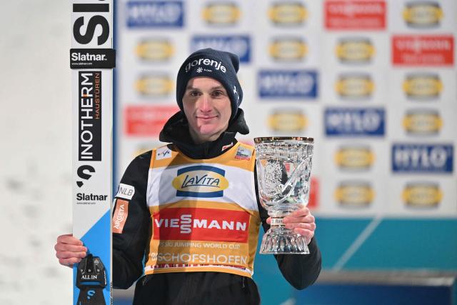 Overall winner and Second placed on the day Slovenia's Domen Prevc poses on the podium after the Men's Individual Large Hill HS142 event of the FIS Ski Jumping World Cup, the fourth and last leg of the Four Hills Tournament, in Bischofshofen, Austria on January 6, 2026. (Photo by KERSTIN JOENSSON / AFP)