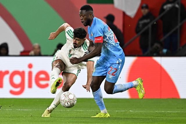 Algeria's forward #9 Baghdad Bounedjah fights for the ball with Democratic Republic Of Congo's defender #22 Chancel Mbemba during the Africa Cup of Nations (CAN) round of 16 football match between Algeria and Democratic Republic of Congo at the Prince Moulay El Hassan Stadium in Rabat on January 6, 2026. (Photo by Gabriel BOUYS / AFP)