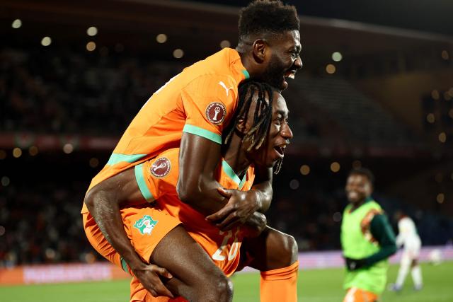Ivory Coast's forward #26 Yan Diomande (R) and Ivory Coast's midfielder #18 Ibrahim Sangare celebrate after the third goal during the Africa Cup of Nations (CAN) round of 16 football match between Ivory Coast and Burkina Faso at the Grand Stadium in Marrakesh on January 6, 2026. (Photo by Franck FIFE / AFP)