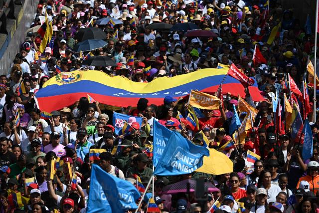 people attend a rally in support of ousted Venezuela's President Nicolas Maduro and his wife Cilia Flores in Caracas on January 6, 2026. US forces killed 55 Venezuelan and Cuban military personnel during their stunning raid to capture Nicolas Maduro, tolls published by Caracas and Havana showed on January 6. (Photo by Federico PARRA / AFP)