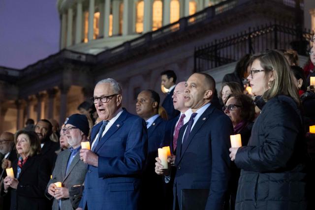US House Minority Leader Hakeem Jeffries, Democrat of New York, and US Senate Minority Leader Chuck Schumer, Democrat of New York, lead Democratic members of Congress and family members of fallen US Capitol Police officers in a singing of ÒGod Bless AmericaÓ following a moment of silence marking the fifth anniversary of the January 6, 2021 attacks on the US Capitol, outside the US Capitol in Washington, DC, on January 6, 2026. (Photo by SAUL LOEB / AFP)