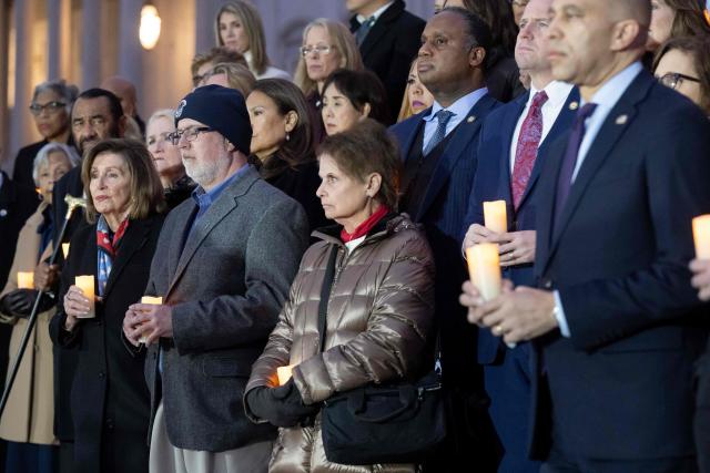 Ken Sicknick (2nd L), brother of late Capitol Police officer Brian Sicknick who died from injuries following the January 6, 2021 attack on the US Capitol, and Sicknick's mother, Gladys Sicknick (2nd R), stand alongside US House Minority Leader Hakeem Jeffries, Democrat of New York, (R) and US Representative and former Speaker of the House Nancy Pelosi (L), Democrat of California, prior to leading Democratic members of Congress and family members of fallen US Capitol Police officers in a moment of silence marking the fifth anniversary of the January 6, 2021 attacks on the US Capitol, outside the US Capitol in Washington, DC, on January 6, 2026. (Photo by SAUL LOEB / AFP)