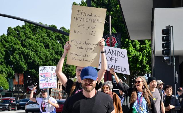 Activists gather to protest against US President Donald Trump's recent action in Venezuela on January 6, 2026 in Pasadena, California, calling on Congress for an immediate end to military action, accountability for President Trump's actions and diplomacy over war. Trump is exploring how to take control of Greenland and using the US military is "always an option," the White House said Tuesday, further upping tensions with NATO ally Denmark. Washington's stark warning came despite Greenland and Denmark both calling for a speedy meeting with the United States to clear up "misunderstandings." The US military intervention in Venezuela has reignited Trump's designs on the autonomous Danish territory in the Arctic, which has untapped rare earth deposits and could be a vital player as melting polar ice opens up new shipping routes. (Photo by Frederic J. BROWN / AFP)