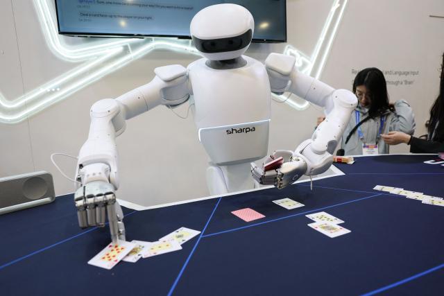 A Sharpa robot deals cards for a game of blackjack during the annual Consumer Electronics Show (CES) in Las Vegas, Nevada on January 6, 2026. (Photo by Patrick T. Fallon / AFP)