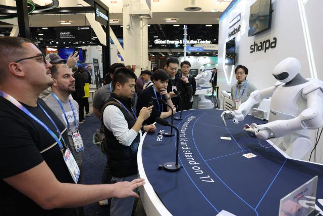 A Sharpa robot deals cards for a game of blackjack during the annual Consumer Electronics Show (CES) in Las Vegas, Nevada on January 6, 2026. (Photo by Patrick T. Fallon / AFP)