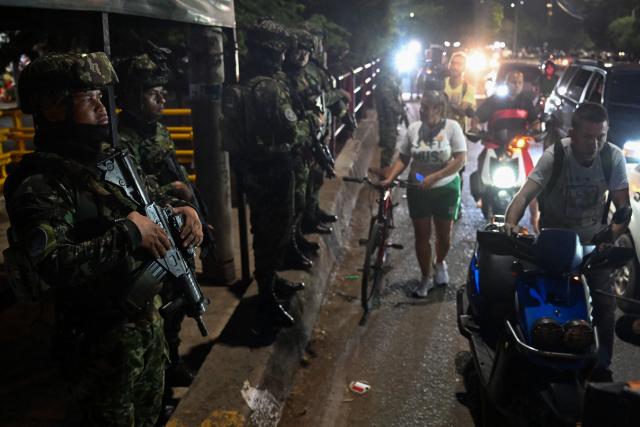 Colombian soldiers patrol the Francisco de Paula Santander International Bridge near the border with Venezuela in Cucuta, Colombia on January 6, 2026. On a bridge on the Colombia–Venezuela border, confusion and hope mix among Venezuelans after the ouster of President Nicolas Maduro and his wife Cilia Flores, while journalists from around the world struggle to cross and report on a story whose outcome remains unclear. (Photo by Raul ARBOLEDA / AFP)
