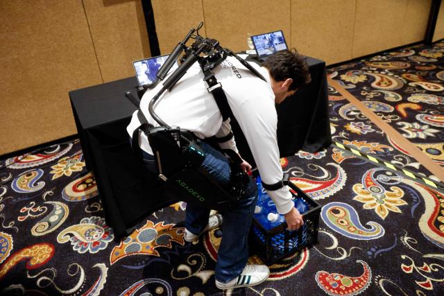 An exhibitor displays AGADE’s Agadexo Lowback, its next-generation AI-driven industrial exoskeleton, during the Showstoppers event at the annual Consumer Electronics Show in Las Vegas, Nevada, on January 6, 2026. (Photo by Caroline Brehman / AFP)