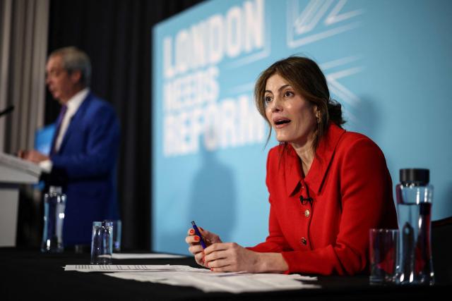 Westminster City councillor Laila Cunningham (R) attends a press conference with Reform UK leader Nigel Farage (back L) in London on January 7, 2026. (Photo by HENRY NICHOLLS / AFP)