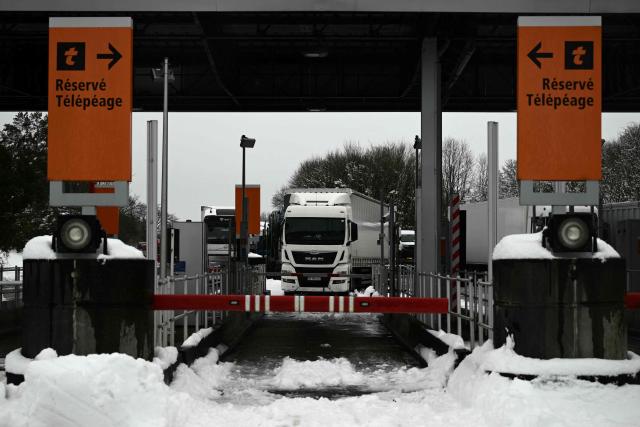 This photograph shows a truck queue to access the A10 motorway at the toll plaza near Saintes, western France, on January 7, 2026, following snowfalls. (Photo by Philippe LOPEZ / AFP)