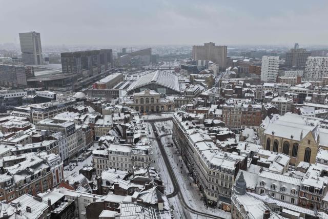 An aerial view shows the Lille - Frandres railway station in downton Lille, northen France, following a fresh snowfall on January 7, 2026. (Photo by Anthony Brzeski / AFP)