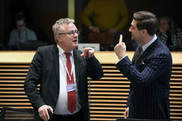 Denmark's Minister of Agriculture Jacob Jensen (L) speaks with Estonia's Agriculture Minister Hendrik Johannes Terras (R) prior to a meeting of EU agriculture ministers on Mercosur agreement at the European Commission in Brussels on January 7, 2026. (Photo by Nicolas TUCAT / AFP)