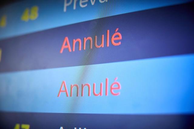 A screen displays canceled flights during a blizzard at Orly Airport, south of Paris on January 7, 2026. Around 100 flights were cancelled at Paris's Charles de Gaulle Airport because of snowfall and fierce cold, and a further 40 were cancelled at Orly Airport, France's transport minister said. (Photo by Kiran RIDLEY / AFP)