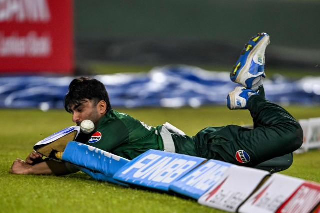 Pakistan's Salman Mirza dives to field the ball near the boundary during the first Twenty20 international cricket match between Sri Lanka and Pakistan at the Rangiri Dambulla International Stadium in Dambulla on January 7, 2026. (Photo by Ishara S. KODIKARA / AFP)