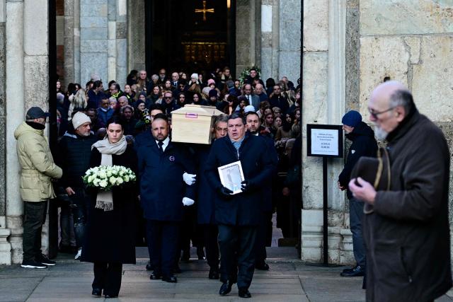 Pallbearers carry the coffin of Achille Barosi, 16 years old, one of the Italian victims of the Crans-Montana new-year fire, at the end of the funeral outside the Basilica of Sant'Ambrogio, in Milan on January 7, 2026. (Photo by Stefano RELLANDINI / AFP)