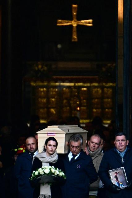 Pallbearers carry the coffin of Achille Barosi, 16 years old, one of the Italian victims of the Crans-Montana new-year fire, at the end of the funeral outside the Basilica of Sant'Ambrogio, in Milan on January 7, 2026. (Photo by Stefano RELLANDINI / AFP)