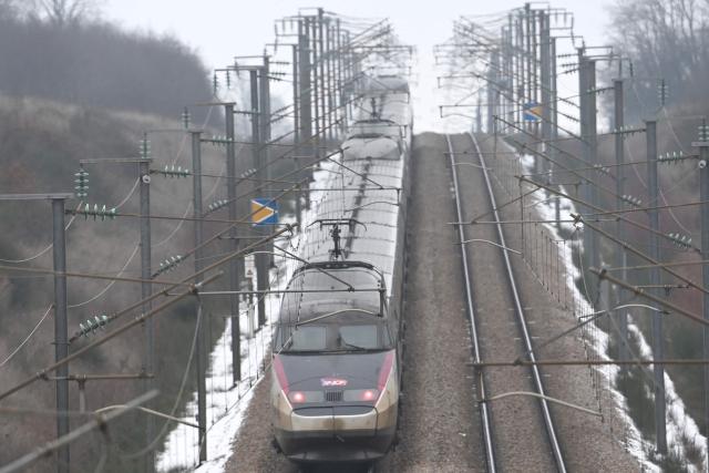 A TGV high-speed train operated by France's SNCF travels at reduced speed on the LGV Paris-Bordeaux line near Courtalain, in central France, after heavy snowfall on January 7, 2025.  (Photo by JEAN-FRANCOIS MONIER / AFP)