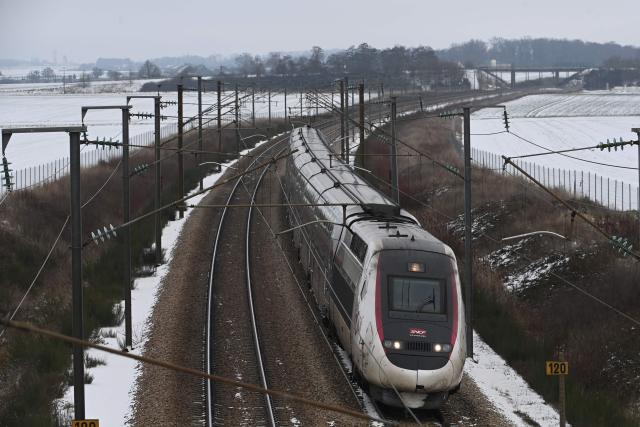 A TGV high-speed train operated by France's SNCF travels at reduced speed on the LGV Paris-Bordeaux line near Courtalain, in central France, after heavy snowfall on January 7, 2025.  (Photo by JEAN-FRANCOIS MONIER / AFP)