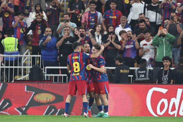 Barcelona's Spanish midfielder #16 Fermin Lopez (R) celebrates with teammates after scoring his team's second goal during the Spanish Supercup semi-final football match between FC Barcelona and Athletic Bilbao at King Abdullah Sports City in Jeddah on January 7, 2026. (Photo by Fadel SENNA / AFP)