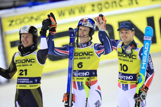 France's Clement Noel (C) celebrates with second placed Finland's Eduard Hallberg (L) and third placed France's Paco Rassat  after the Men's Slalom event, part of the FIS Alpine Ski World Cup 2025-2026, in Madonna di Campiglio, northern Italy, on January 7, 2026. (Photo by Pierre TEYSSOT / AFP)