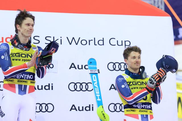 First placed France's Clement Noel (L) celebrates on the podium with third placed France's Paco Rassat after the Men's Slalom event, part of the FIS Alpine Ski World Cup 2025-2026, in Madonna di Campiglio, northern Italy, on January 7, 2026. (Photo by Pierre TEYSSOT / AFP)