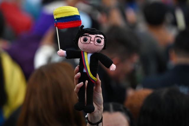 TOPSHOT - A crochet-made doll depicting Colombian President Gustavo Petro is seen during the March for Sovereignty and Democracy against US President Donald Trump's threats to Colombia's President Gustavo Petro at Bolivar Square in Bogota on January 7, 2026. On January 5, Colombian President Gustavo Petro said he was ready to "take up arms" in the face of threats from US counterpart Donald Trump, who over the weekend seized the leader of neighboring Venezuela in a military strike. (Photo by LUIS ACOSTA / AFP)
