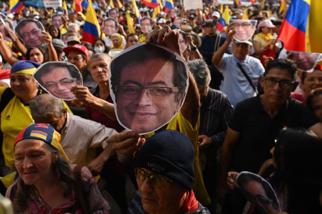 A man holds an image of Colombia’s President Gustavo Petro during the March for Sovereignty and Democracy against U.S. President Donald Trump’s threats to Petro in Cali, Colombia, on January 7, 2026. On January 5, Colombian President Gustavo Petro said he was ready to "take up arms" in the face of threats from US counterpart Donald Trump, who over the weekend seized the leader of neighboring Venezuela in a military strike. (Photo by Joaquin SARMIENTO / AFP)
