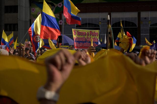 Demonstrator wave Colombian flags during the March for Sovereignty and Democracy against US President Donald Trump's threats to Colombia's president in Cali, Colombia, on January 7, 2026. On January 5, Colombian President Gustavo Petro said he was ready to "take up arms" in the face of threats from US counterpart Donald Trump, who over the weekend seized the leader of neighboring Venezuela in a military strike. (Photo by Joaquin SARMIENTO / AFP)