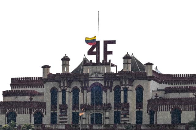 The Cuartel de la Montaña (Mountain Barracks), the 4F fort overlooking Caracas which is also home to the mausoleum of late president Hugo Chavez, is seen with the Venezuelan flag at half-mast on January 7, 2026. Deposed Venezuelan president Nicolas Maduro was snatched by US forces in a stunning raid on his home in Caracas on January 3, 2026, and taken to New York to face drug trafficking and other related charges. (Photo by Ronaldo SCHEMIDT / AFP)