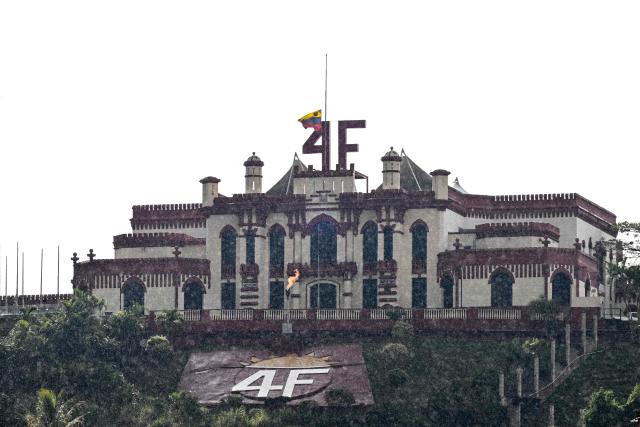 The Cuartel de la Montaña (Mountain Barracks), the 4F fort overlooking Caracas which is also home to the mausoleum of late president Hugo Chavez, is seen with the Venezuelan flag at half-mast on January 7, 2026. Deposed Venezuelan president Nicolas Maduro was snatched by US forces in a stunning raid on his home in Caracas on January 3, 2026, and taken to New York to face drug trafficking and other related charges. (Photo by Ronaldo SCHEMIDT / AFP)