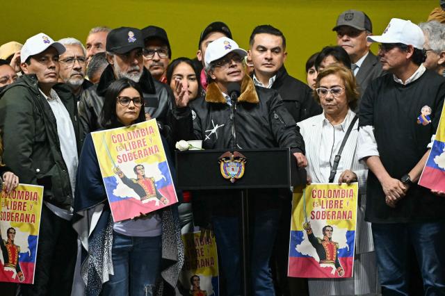 TOPSHOT - Colombia’s President Gustavo Petro sings the national anthem during the March for Sovereignty and Democracy against US President Donald Trump’s threats to Petro at Bolivar Square in Bogota on January 7, 2026. Donald Trump held his first phone call with Colombian counterpart Gustavo Petro on January 7, the foreign ministry in Bogota said, days after the US President threatened him with military action. (Photo by Luis ACOSTA / AFP)