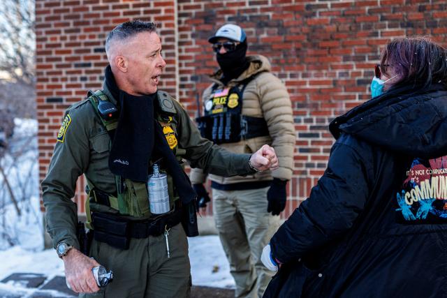 US Border Patrol Commander Gregory Bovino argues with protesters near Roosevelt High School during dismissal time in Minneapolis, Minnesota, on January 7, 2026. An immigration officer in Minneapolis shot dead a woman Wednesday, triggering outrage from local leaders even as US President Donald Trump claimed the officer acted in self-defense. Minneapolis Mayor Jacob Frey deemed the government's allegation that the woman was attacking federal agents "bullshit," and called on Immigration and Customs Enforcement (ICE) officers conducting a second day of mass raids to leave Minneapolis. (Photo by Kerem YUCEL / AFP)