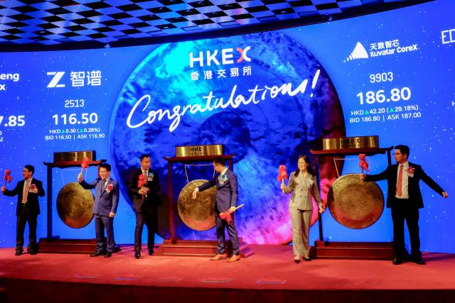 Company executives from Chinese large language model developer Zhipu AI, semiconductor Iluvatar CoreX, and surgical robot manufacturer Edge Medical attend the initial public offering (IPO) launch at the Hong Kong Stock Exchange (HKEX) on January 8, 2026. Leading Chinese artificial intelligence startup Zhipu AI rose as it went public in Hong Kong on January 8, a day before rival MiniMax also makes its market debut in a litmus test for the country's rapidly developing sector. (Photo by Tommy WANG / AFP)