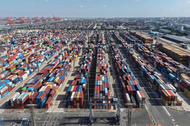 An aerial view shows shipping containers at the Shanghai Port container terminal in Shanghai on January 8, 2026. (Photo by AFP) / China OUT