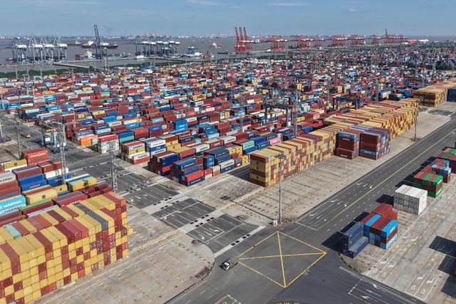 An aerial view shows shipping containers at the Shanghai Port container terminal in Shanghai on January 8, 2026. (Photo by AFP) / China OUT