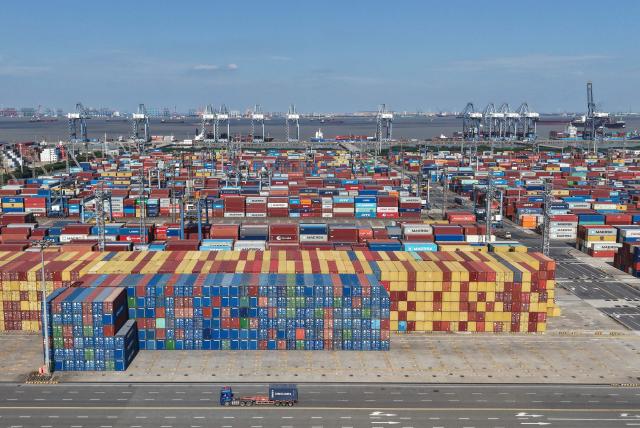 An aerial view shows shipping containers at the Shanghai Port container terminal in Shanghai on January 8, 2026. (Photo by AFP) / China OUT
