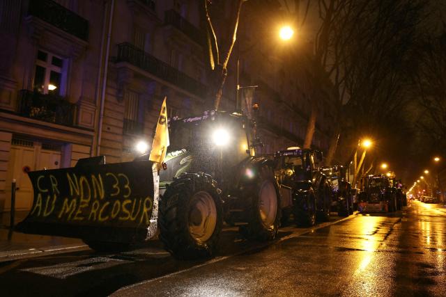 Tractors are parked next to the Eiffel Tower during a demonstration by the French farmers union FDSEA Ile de France as part of a nationwide day of protests and actions called by several farmers unions to push the French government to block the Mercosur trade deal and protest against its handling of the nodular dermatitis (CND) epidemic, in Paris on January 8, 2026. (Photo by Thomas SAMSON / AFP)