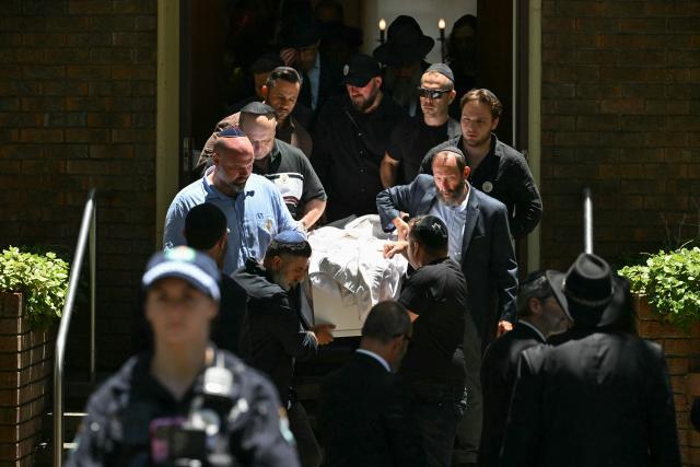 (FILES) Mourners carry out the coffin of 10-year-old Matilda, who was killed in the December 14 Bondi Beach shooting attack, after the funeral service in Sydney on December 18, 2025. Australia will hold a royal commission inquiry into the mass shooting that killed 15 people at Bondi Beach, Prime Minister Anthony Albanese said on January 8, 2026, as he faced public demands for answers. (Photo by Saeed KHAN / AFP)