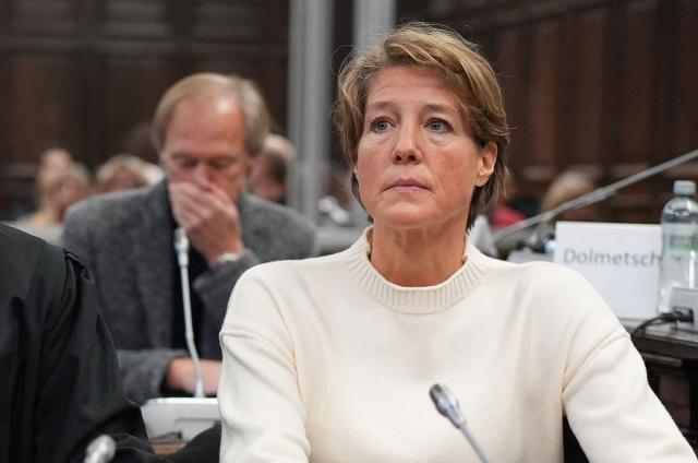 Defendant German entrepreneur and gastronome Christina Block (R) looks on in front of  German former sports journalist Gerhard Delling as they wait for the continuation of the trial against Christina Block over alleged child abduction at the District Court in Hamburg, northern Germany, on January 8, 2026. The public prosecutor's office accuses Block, heiress of a steakhouse chain, of ordering the abduction of her daughter, born in 2010, and her son, born in 2013. According to the indictment, the background to this is an escalating custody dispute over many years between Block and her former husband, who have four children together. The latter kept the two youngest children with him in August 2021 after an agreed visit to Gravenstein in southern Denmark near the German border, where he had been living for some time. (Photo by Marcus Brandt / dpa / AFP)