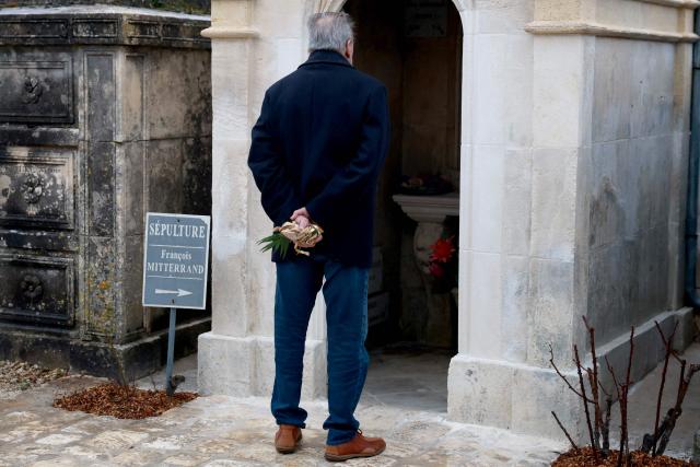 A man stands in front of the tomb of  late French Socialist president Francois Mitterrand during a ceremony marking the 30th anniversary of his death, in January 8, 2026. (Photo by ROMAIN PERROCHEAU / AFP)