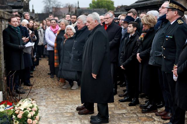 (From L) The youngest son of Francois Mitterrand, Gilbert Mitterrand (front) and former Socialist minister Jean Glavany  (C,L) stand near the tomb of  late French Socialist president Francois Mitterrand on the 30th anniversary of his death, on January 8, 2026. (Photo by ROMAIN PERROCHEAU / AFP)