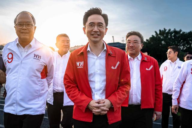Pheu Thai Party prime ministerial candidate Yodchanan Wongsawat (C) arrives during the party’s first major rally at Lan Khon Mueang in Bangkok on January 8, 2025. (Photo by Chanakarn Laosarakham / AFP)