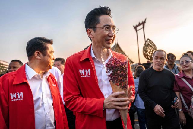 Pheu Thai Party prime ministerial candidate Yodchanan Wongsawat (C) gestured as he arrives during the party’s first major rally at Lan Khon Mueang in Bangkok on January 8, 2025. (Photo by Chanakarn Laosarakham / AFP)